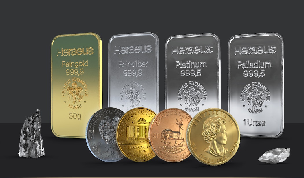 Vor einem dunklen Hintergrund stehen Edelmetallbarren (Gold, Silber, Platin und Palladium) vor diesen sind ein Silbermünze und drei Goldmünzen. Rechts und links der Edelmetallbarren und -münzen sind zwei Technologiemetalle platziert. All diese Metalle sind im Simple Sparplan von Golden Gates.
